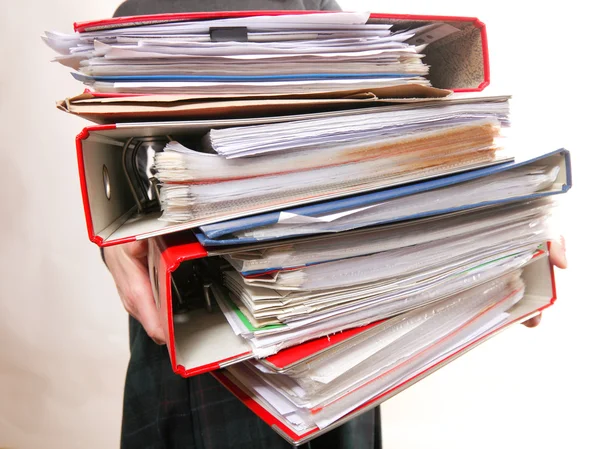 Female office worker carrying a stack of files — Stock Photo, Image