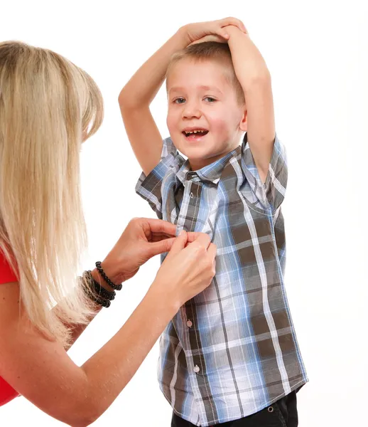 Mother fixing young boy shirt — Stock Photo, Image