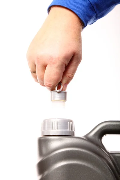 Hand opening can with car engine oil isolated — Stock Photo, Image