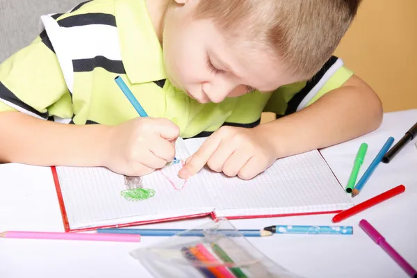 Young cute boy draws with color pencils Stock Image