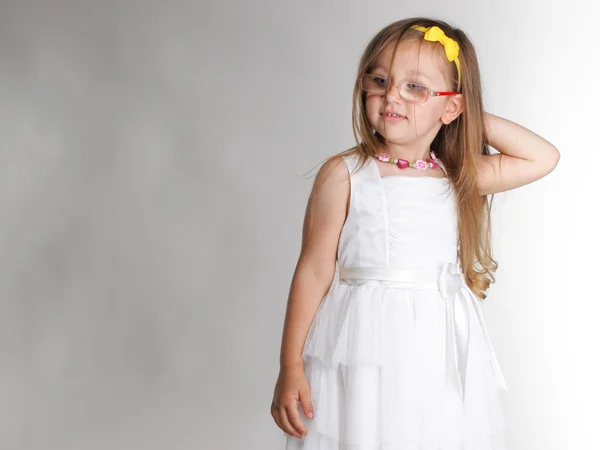 Cute little girl in white dress glasses — Stock Photo, Image