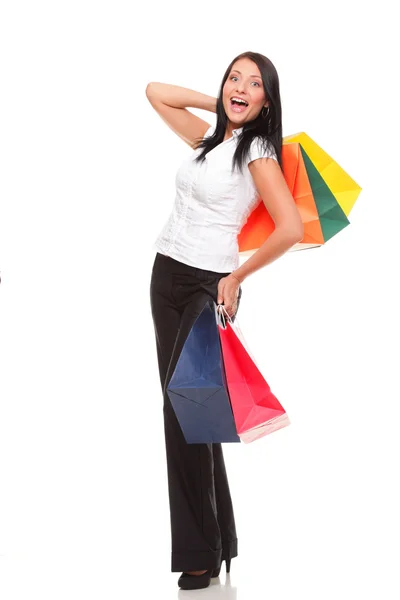 Portrait of young woman carrying shopping bags against white bac — Stock Photo, Image