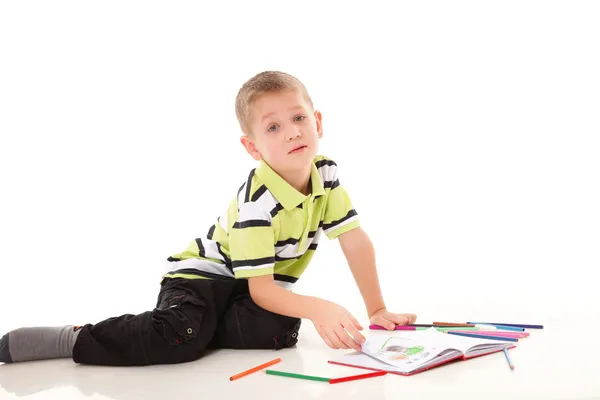 Young boy draws with color pencils isolated Stock Image