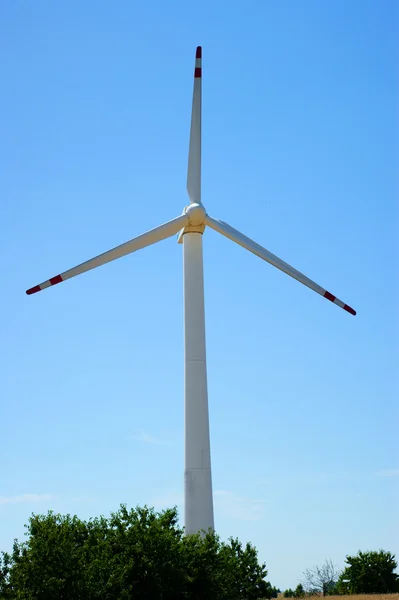 Wind power turbine, forest - blue sky — Stock Photo, Image