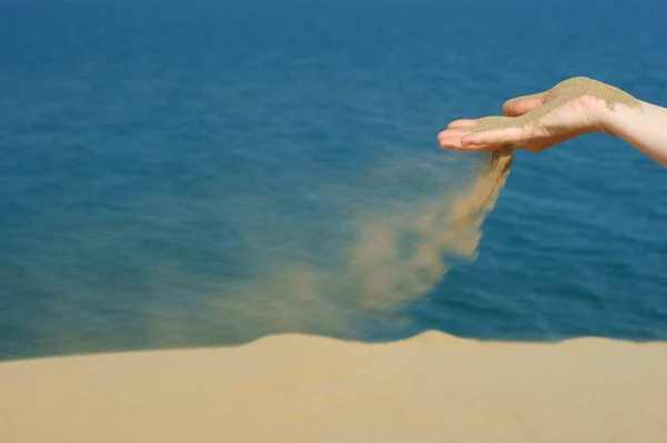 Sand in female hand — Stock Photo, Image