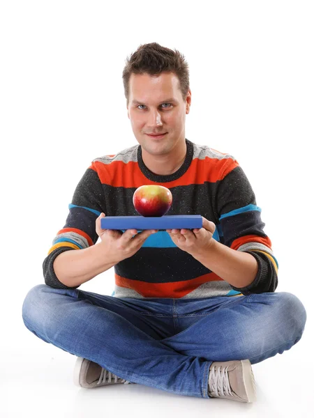 Man holding a book and one red apple full body — Stock Photo, Image