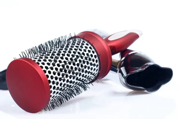 Red round comb and hairdryer isolated on a white — Stock Photo, Image