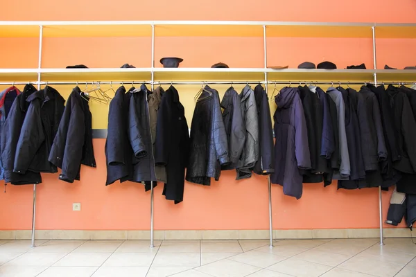 Many clothes in cloakroom — Stock Photo, Image