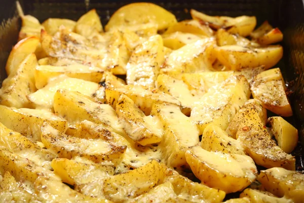 Roasted potatoes with spices and cheese — Stock Photo, Image