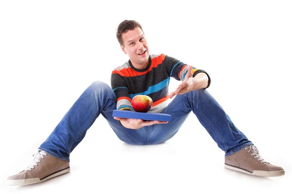 Man holding a book and one red apple full body — Stock Photo, Image