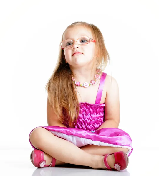 Cute little girl glasses sitting on floor isolated — Stock Photo, Image