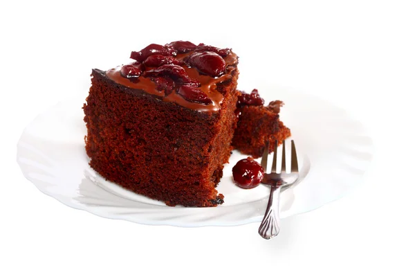 Piece of chocolate cake with icing and cherry — Stock Photo, Image