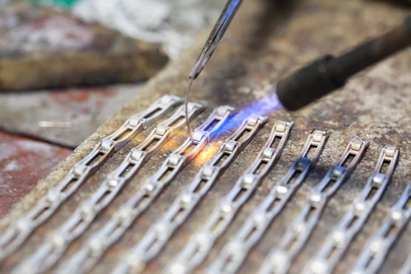 Cloceup jeweller at work silver soldering — Stock Photo, Image