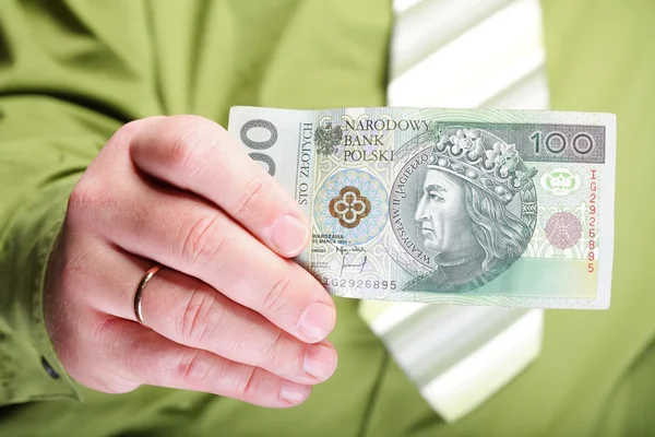 Businessman holding money 100 polish zloty — Stock Photo, Image