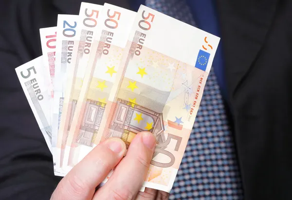 Euro banknotes in male hand — Stock Photo, Image