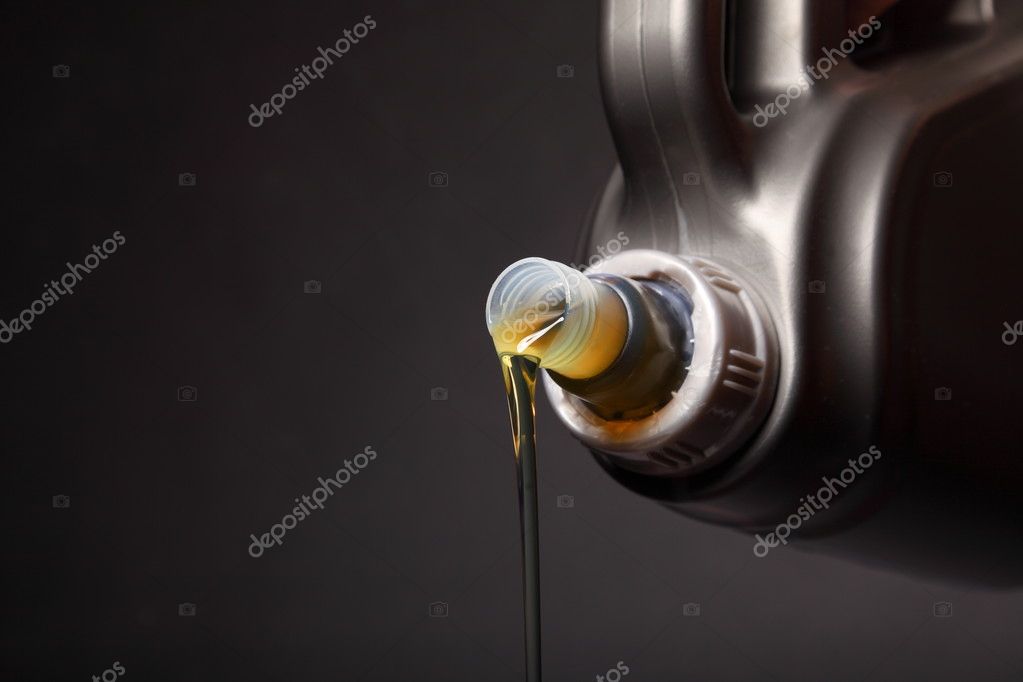 Can with car engine oil pouring black background Stock Photo by