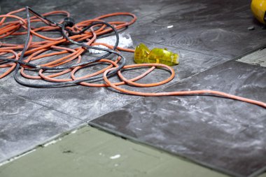 coils of electrical cable lying on floor workplace clipart