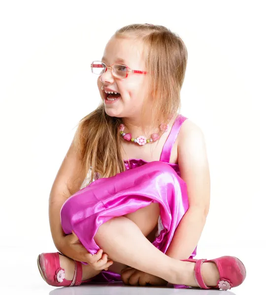 Cute little girl sitting and smiling, isolated — Stock Photo, Image