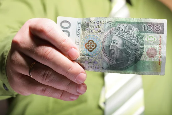 Businessman holding money 100 polish zloty — Stock Photo, Image