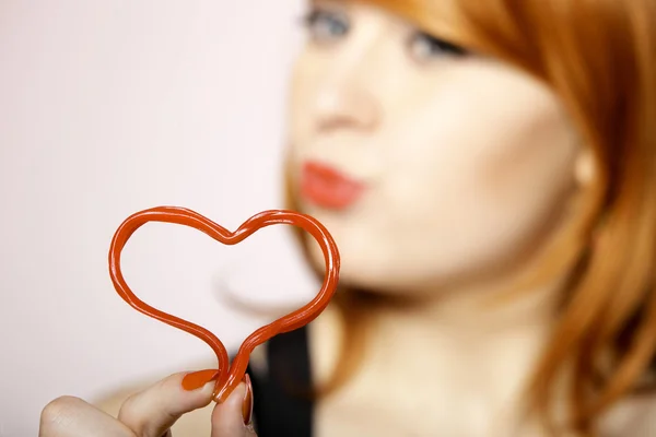 Happy redhair girl with heart love symbol — Stock Photo, Image