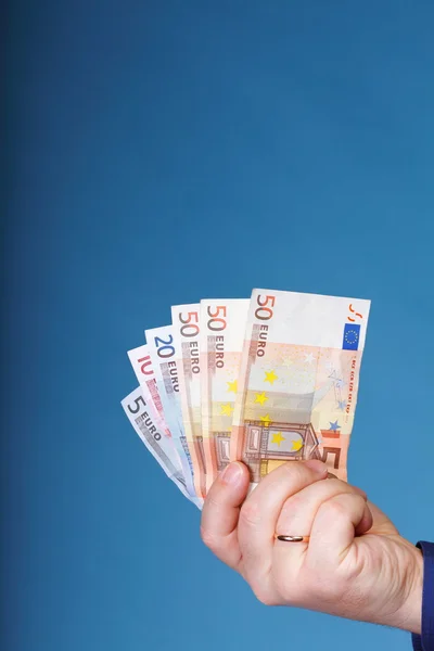 Euro banknotes in male hand — Stock Photo, Image
