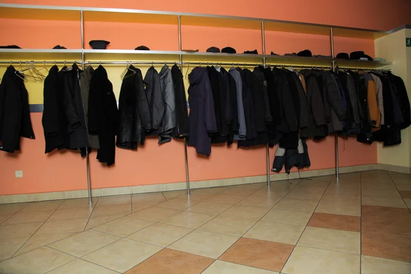 Many clothes in cloakroom — Stock Photo, Image