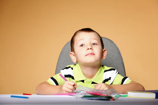 Young cute boy draws with color pencils Stock Image