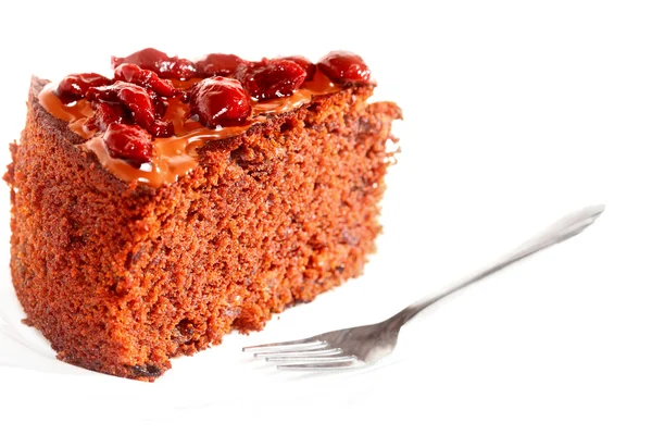 Piece of chocolate cake with icing and cherry — Stock Photo, Image