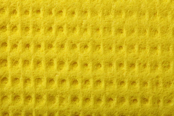 Geel sponsschuim als achtergrond textuur — Stockfoto