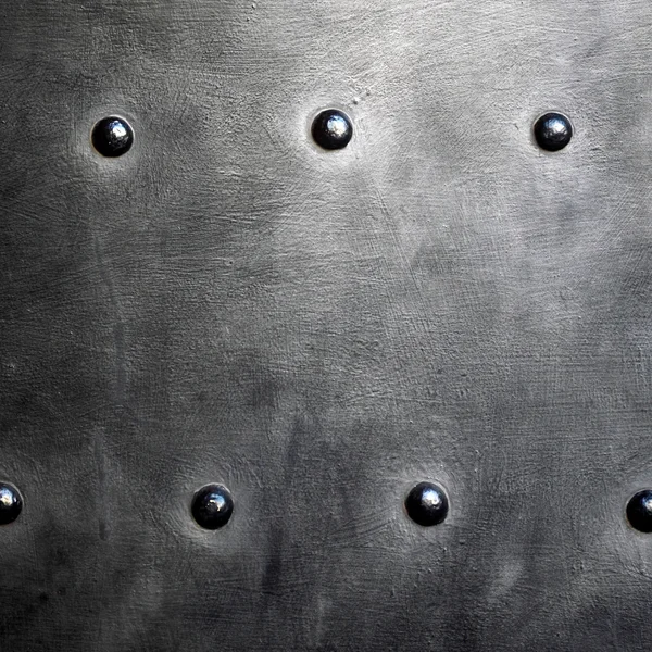 Black metal plate or armour texture with rivets — Stock Photo, Image