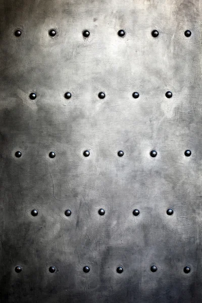 Black metal plate or armour texture with rivets — Stock Photo, Image