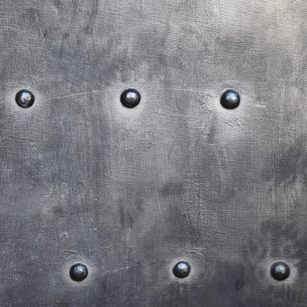 Black metal plate or armour texture with rivets — Stock Photo, Image