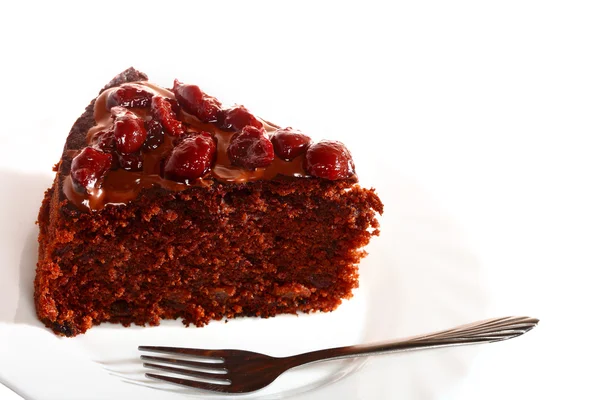 Piece of chocolate cake with icing and cherry — Stock Photo, Image