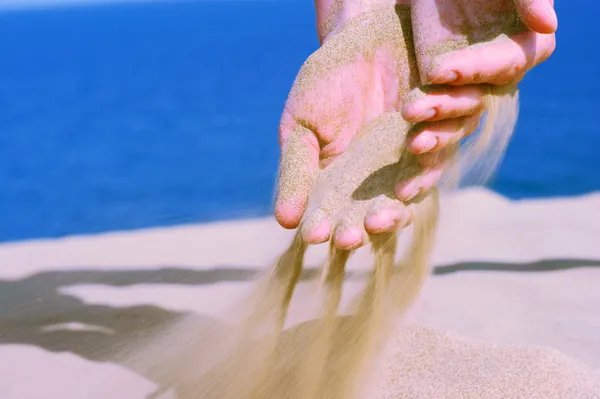 Sand in female hand — Stock Photo, Image