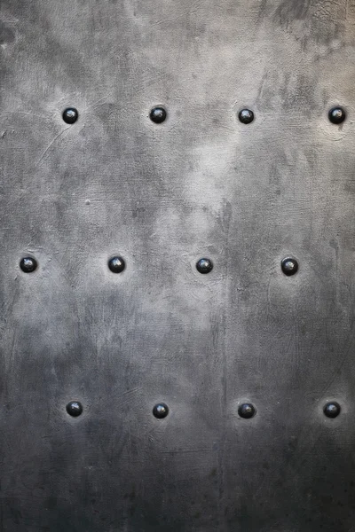 Black metal plate or armour texture with rivets — Stock Photo, Image