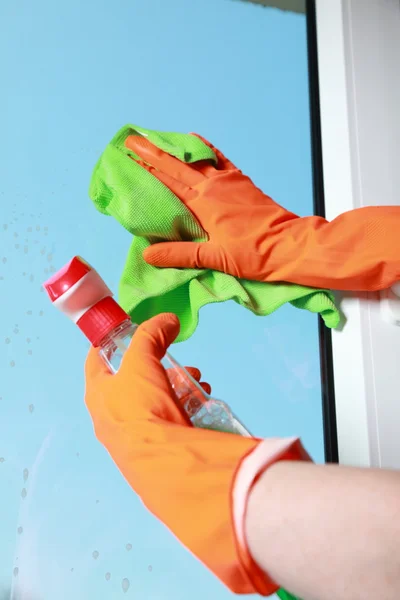 Gloved hand cleaning window rag and spray — Stock Photo, Image