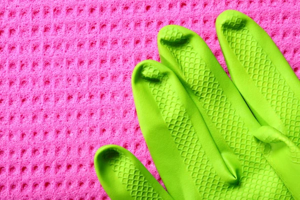 Pink sponge and green rubber glove — Stock Photo, Image