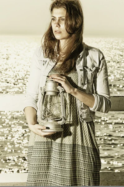 Chica en el muelle con lámpara de queroseno — Foto de Stock