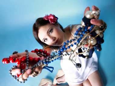summer girl plenty of jewellery beads in hands clipart