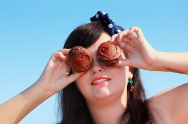 portrait of brunette girl with two cakes clipart
