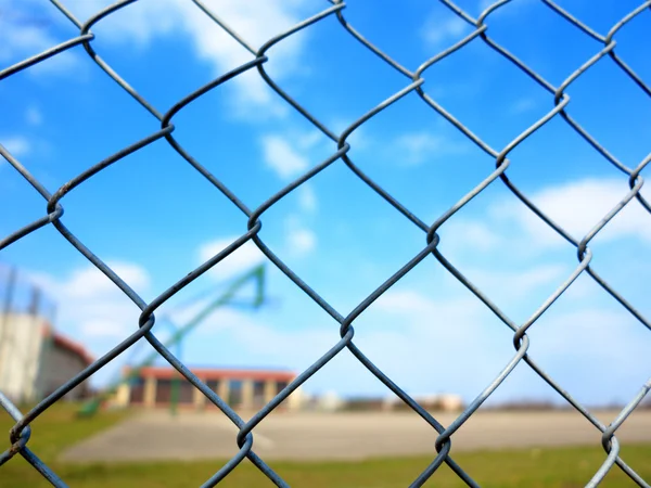 Metal mesh with blur basketball court background — Stock Photo, Image
