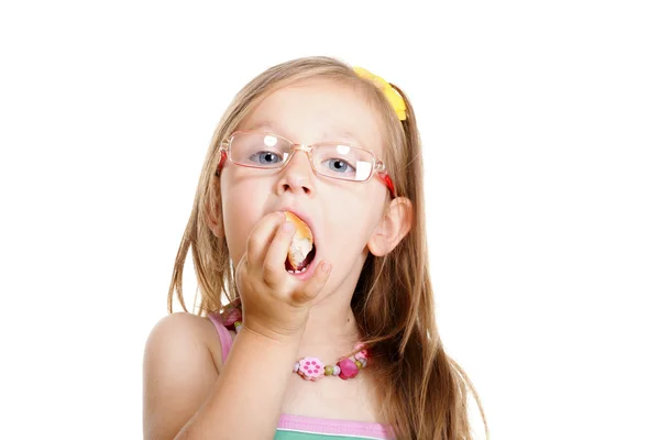 Little girl eating bread doing fun isolated — Stock Photo, Image