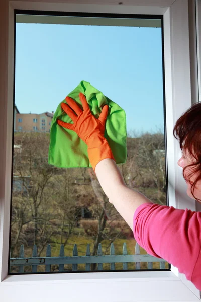 Gloved hand cleaning window with rag — Stock Photo, Image