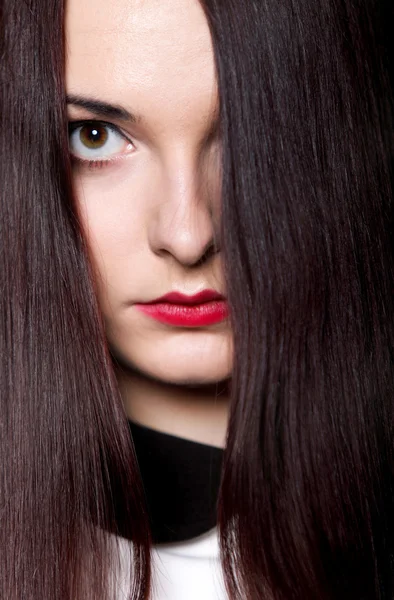 Woman covers part of face by straight long hair — Stock Photo, Image