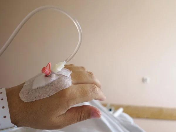 Patient's hand in the hospital with an IV — Stock Photo, Image