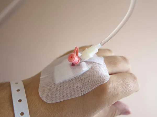 Patient's hand in the hospital with an IV — Stock Photo, Image
