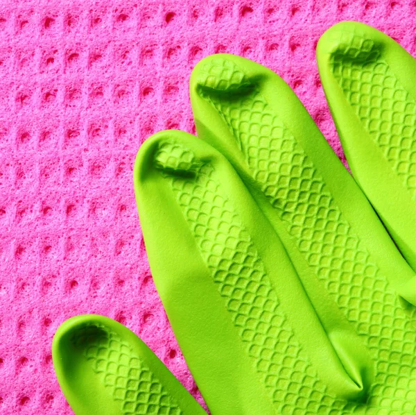 Pink sponge and green rubber glove — Stock Photo, Image