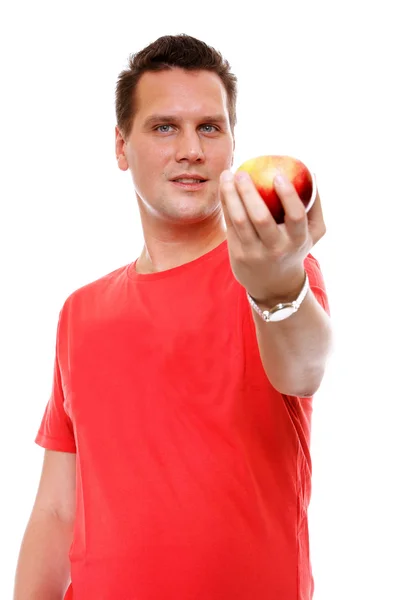 Handsome man in red shirt with apple isolated Royalty Free Stock Images