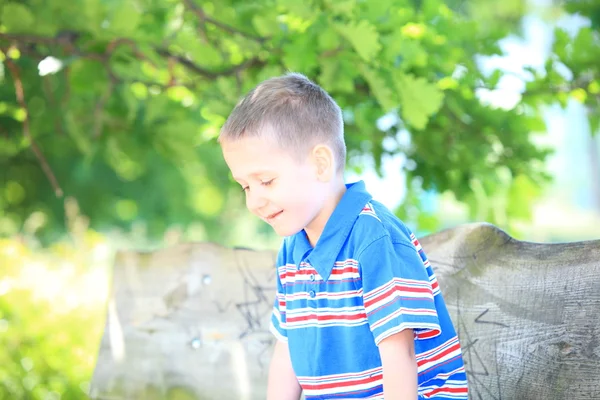 Happy family mother and son on bench in park — Stock Photo, Image