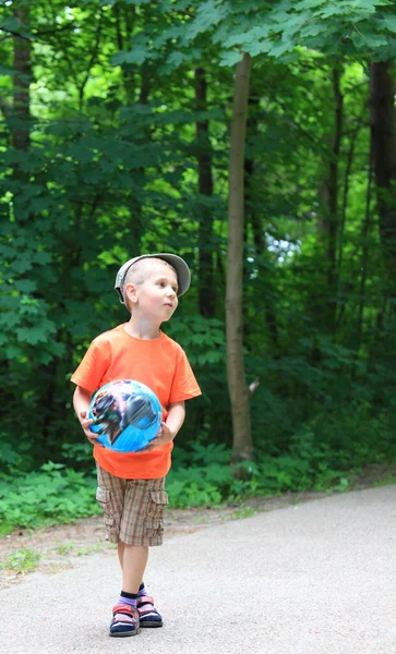 Pojke leker med boll i parken utomhus — Stockfoto